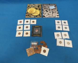 Lot 237. Coin stew including dimes, pennies, Canadian pennies, and two empty coin books