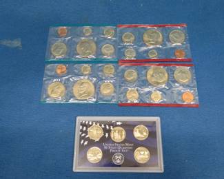 Lot 114. Two 1977 uncirculated coin sets. Each set has P and D coin sleeves  2003 5-quarter set of State Quar