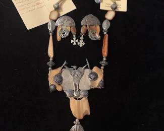 Mary & Doug Hancock/Mummy's Bundle Egyptian clay with Navajo buttons and feather necklace and earring set, 1995