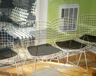 Harry Bertoia for Knoll style white chairs with black pads. 