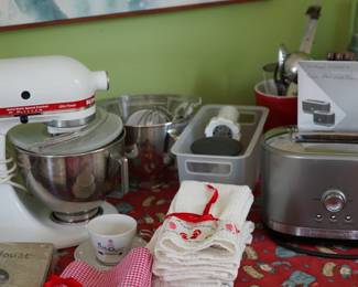 Tables of cookware, bakeware, linens and utensils. 