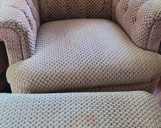 One of a pair of upholstered chairs with ottomans