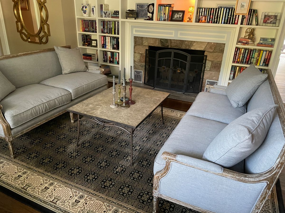 Pair of matched couches (w down inserts), 100% wool large area rug (11' x 8'), cocktail table - metal base, and large gold art deco mirror, books and more!