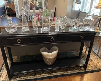 Black ebony with waxed finish console table (narrow) with 3 drawers and lower tier; Baccarat, Tiffany & Co, Waterford, and Simon Pierce - collection of crystal decanters, vases, and pitchers