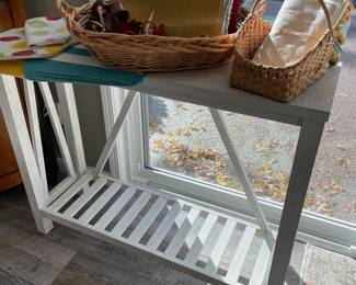 White console table with lower tier; placemats, napkins, and napkin rings