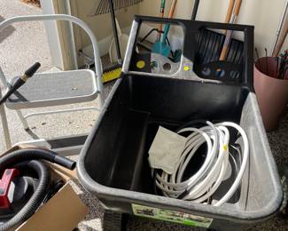 Step-stool, plastic wheel barrow, hose, and shop vac