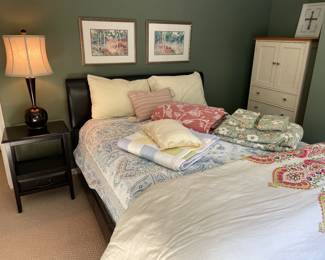 Queen leather bed with headboard and square base (no footboard), mattress, nightstand, lamp, and tall dresser cabinet, duvet and quilts