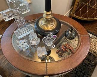 Top of metal side table with glass and leather trim; glass and crystal figurines and cross (Simon Pierce, Waterford and Swarovski)