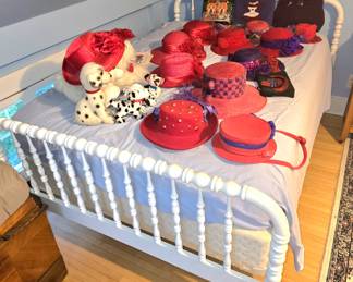 White Jenny Lind bed. Red Hats and purses