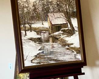Woodsy painting shown on Easel, one of 2 by artist.