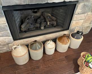 Multiple antique whiskey jugs