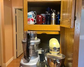 Yellow KitchenAid stand mixer. Cuisinart food processor