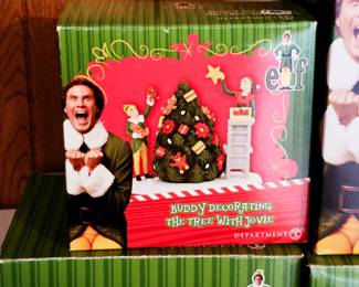 Elf the movie buddy decorating the tree with Jovie dept 56 Christmas Village 