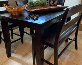 counter height table with bench seat and 4 chairs, and fold out leaf