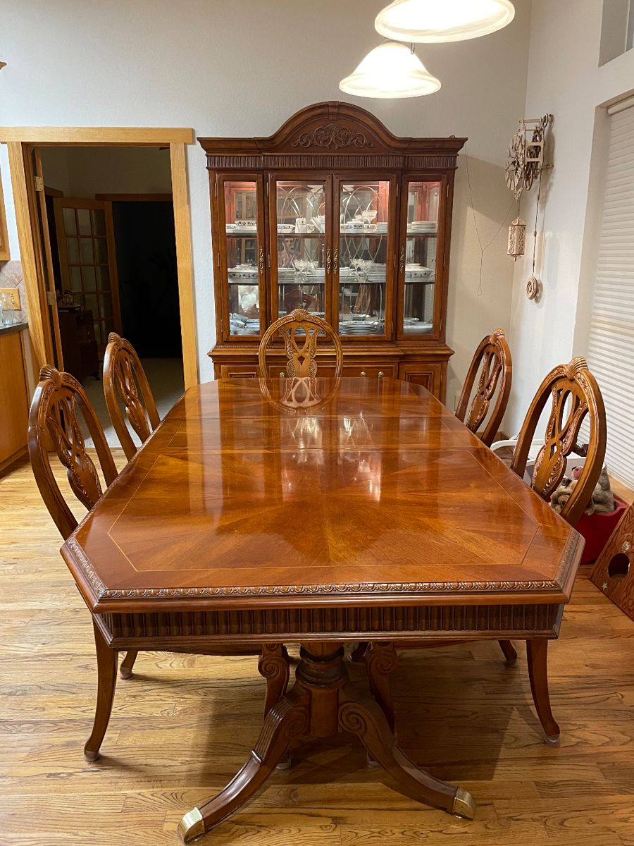 Dining table includes a leaf and heat protective cover.