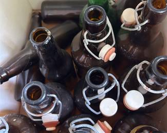 Grolsch beer bottles, amber and green, several boxes