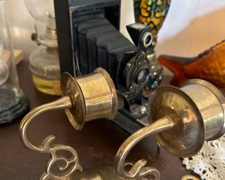 Old camera, brass candlestick sconces 
