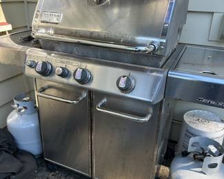 Weber BBQ grill and propane tanks