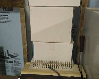 GBC Binding Machine With Five Boxes Various Levels Of Fullness Of Plastic Binder Spirals