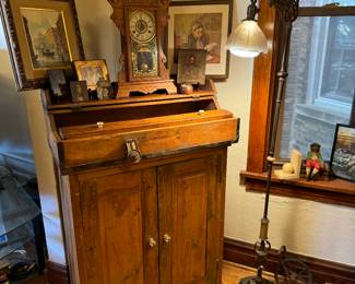 Two piece wooden cabinet top piece is an anti-travel desk.  