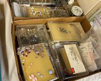 Boxes, flats, and jars of semi-precious stones, and jewelry findings and supplies