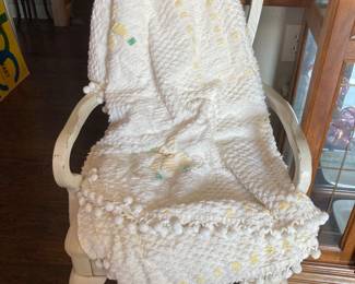 White chair and chenille bedspread 