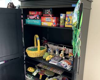 Seasonal and games. Nice black armoire cabinet.