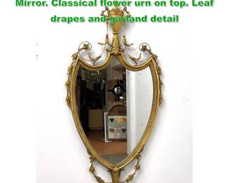 Lot 1624 Gilt Wood Decorative Shield form Mirror. Classical flower urn on top. Leaf drapes and garland detail