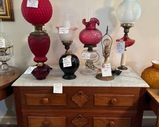 Marble top chest of drawers with various lamps