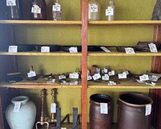 Old crocks, andirons, cast iron, bottles, stirrups and more