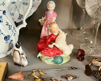 Collectibles from all around the world, royal doultons in background.
