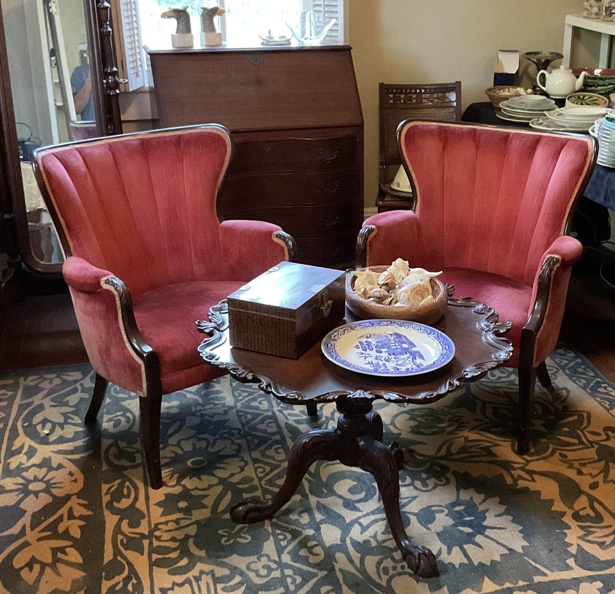 Pair of red upholstered arm chairs, mahogony round pie crust table, fold out desk, nice large area rug, mirror