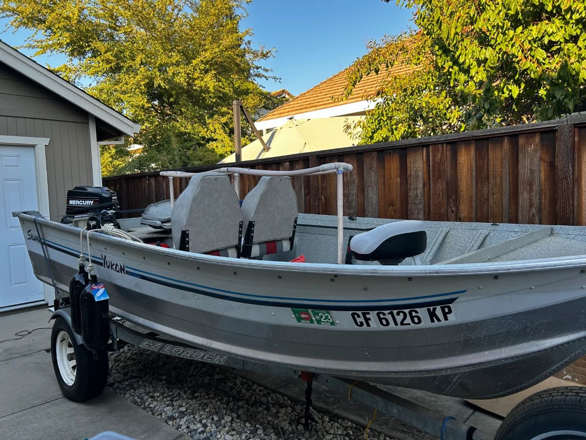 1991 Syvan Yukon fishing boat.  Incl:  15 HP 2 stroke Mercury motor, Bimini top (near new), trailer (good tires)- registration is good until 2025.  $2200/B.O. by Sun pm