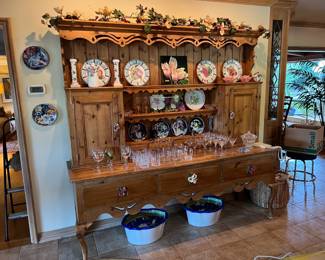 Of course, here you can see not only the finely crafted country-style kitchen hutch, but also the plates and stemware.
