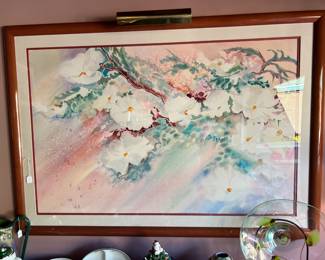 Another framed artwork item is hanging on the wall here.