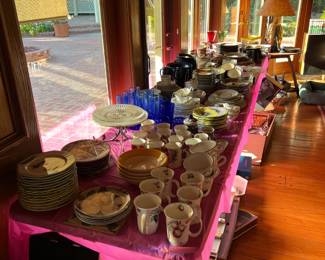 These tables are full of various cups, saucers, plates, serving dishes, cake platters, and a bunch more.