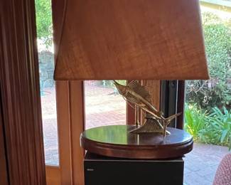 This lamp on top of a stereo speaker features a brass sailfish.