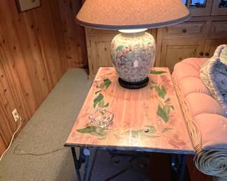 This table is very solid.  Wrought iron base and a stone top.  Of course, the lamp is nice, too.