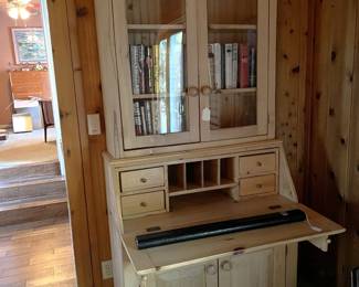 This secretary's desk is also great for holding books.  Oh, and the long black tube holds a pool cue.  There is one "butt" and two "sticks".  There is a stylized lion imprinted in the butt sleeve.