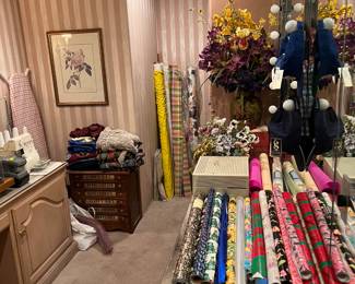 On the far left, almost out of frame is a serger.  Out of frame is the sewing machine.  Otherwise, this back room has wrapping paper.  Remember the holidays are coming up....