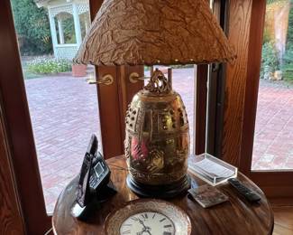 The interesting focus in this picture is the brass lamp on the table.  But maybe you're more interested in the table itself.  Or the clock plate?  