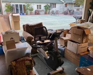 A recumbent bicycle exerciser is shown here in front of another chair.