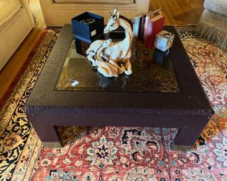 Notice both the rug and the coffee table, then you can see the giraffe statue.