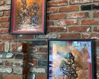Framed, embossed copper art pieces are shown here.