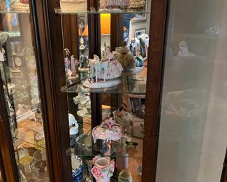 This display cabinet (it's lighted, of course) can display all sorts of things like these figurines and cups.