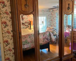 This is an unusual piece: a double armoire, and it is mirrored.