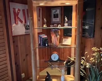 Here is the lighted shelf unit that had the mantle clock.  Look closely at the other shelves, and notice the framed movie items on the wall behind.