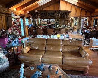 There is a lot happening in this photo.  Take your time and notice the sofa, the hexagonal coffee table in the foreground, then the barstools in the background.  The Bang & Olufsen stereo is behind the bar, as is the Pepsi dispenser.