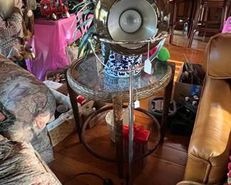 It's a bit challenging to see here, but there is a stand lamp just in front of the round, glass-topped side table.  The lamp can be aimed and has a smoke-colored globe mounted on the frame. 