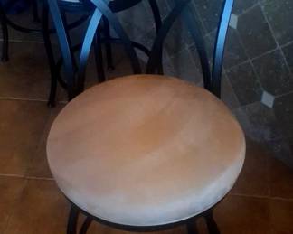 Four bar stools that swivel.